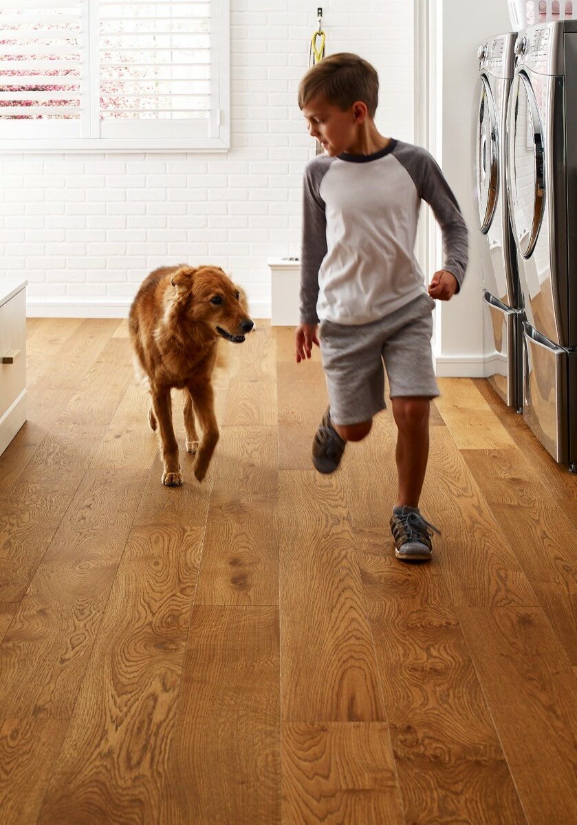 Kid running with dog | Raider Flooring